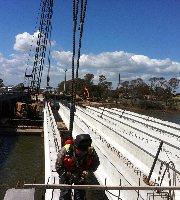 Worker standing on bridge girders during construction